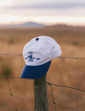 White and Liberty-blue Marfa Country Club Rider’s Cap in the West Texas desert