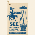 See Mystery Lights golf towel on a smooth warm beige background