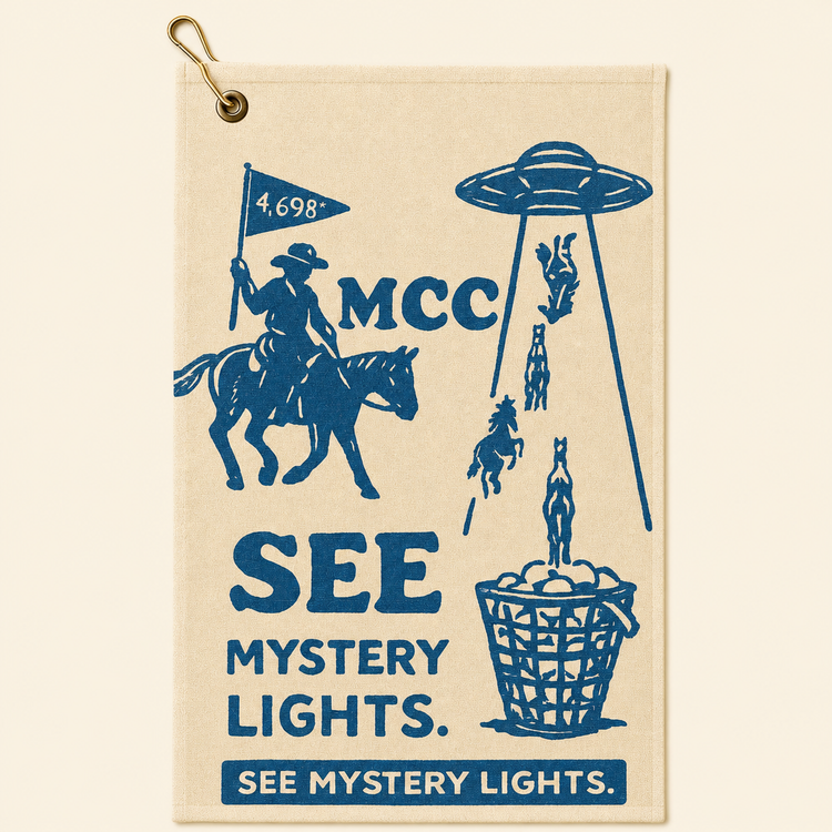 See Mystery Lights golf towel on a smooth warm beige background